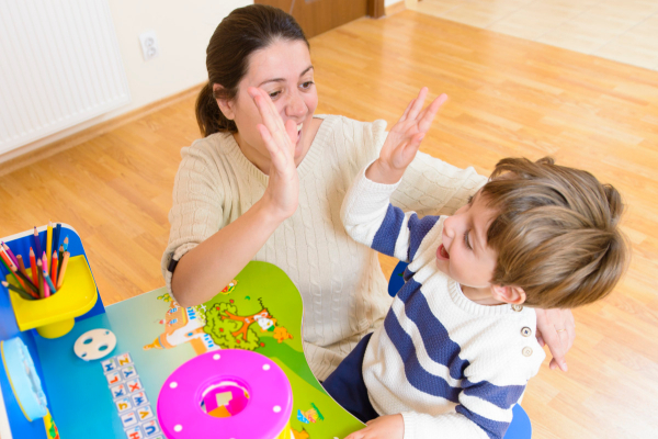 a picture of a mom showing you how to teach phonics at home and making it fun for her child