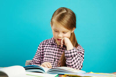 A fluent young girl reading her book out aloud