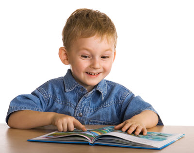 A happy and motivated boy in Gr 2 reading a book