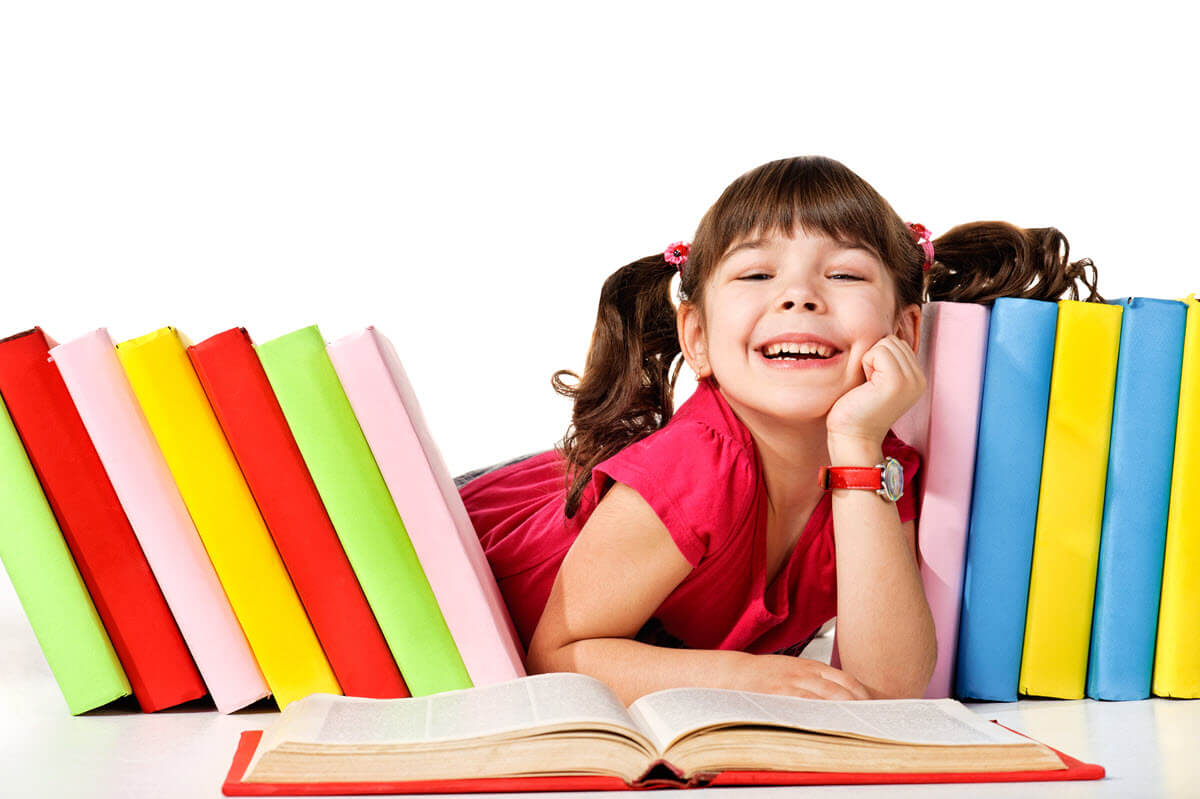 Read aloud benefits featured image of a girl surrounded by the books she enjoys to read
