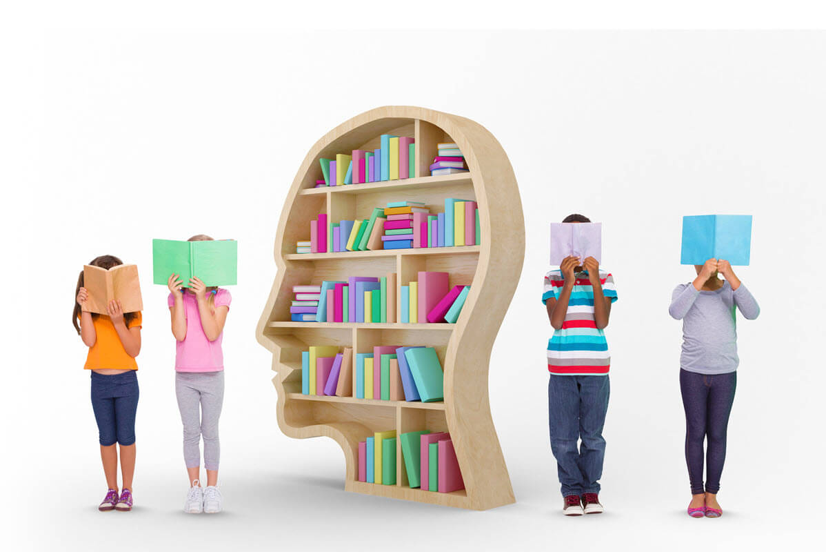 5 stages of literacy development featured image of 4 kids standing next to a book shelf while reading