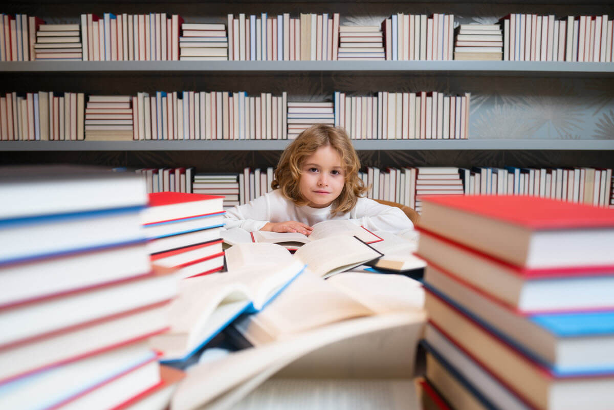 how does reading help the brain featured image of a young boy surrounded by books