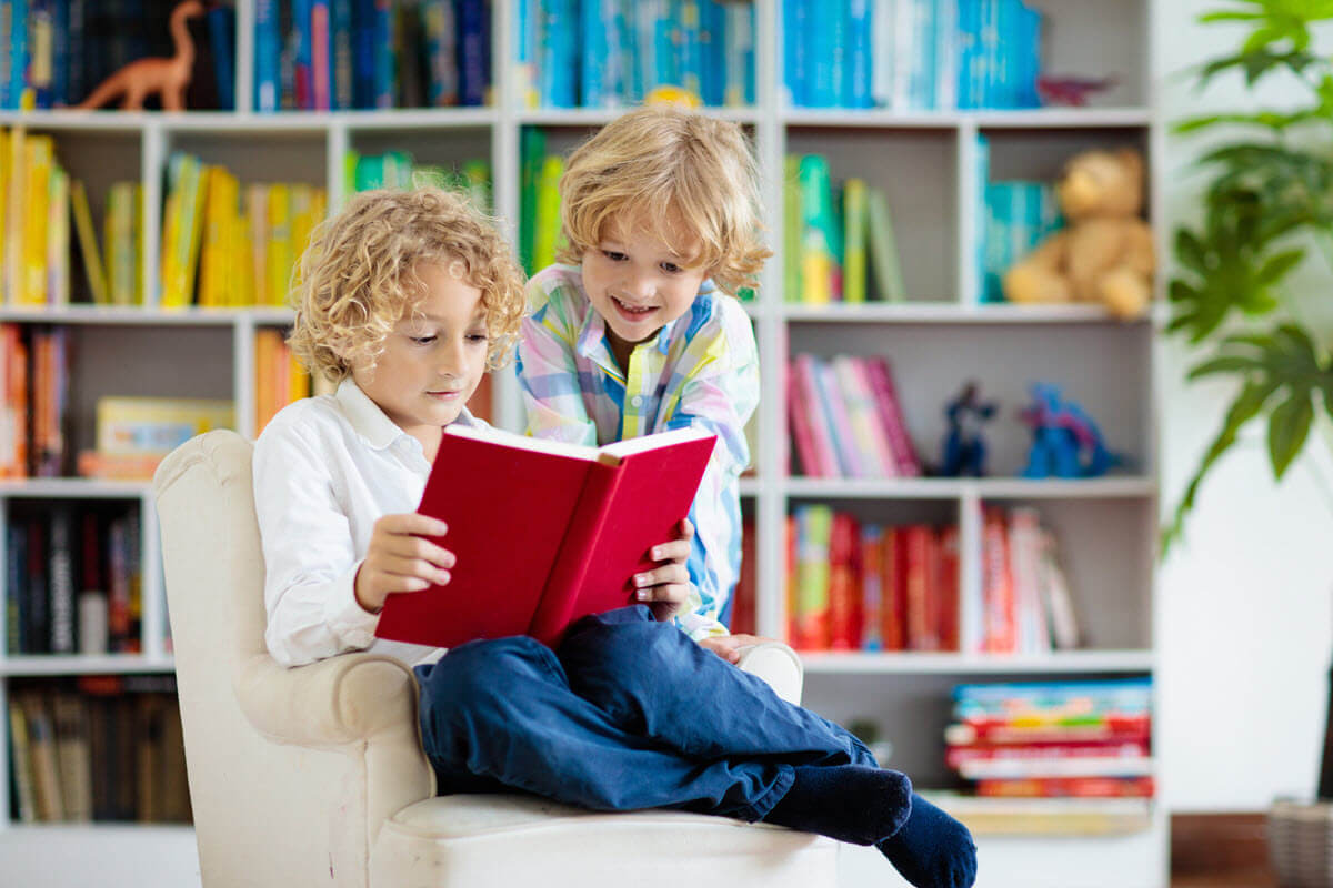 What are long and short vowels featured image of 2 young boys sitting on the sofa and reading a book