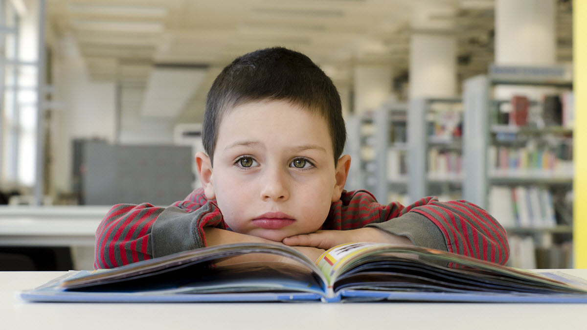 alphabet letters in order with numbers featured image showing a boy sitting in the library while reading